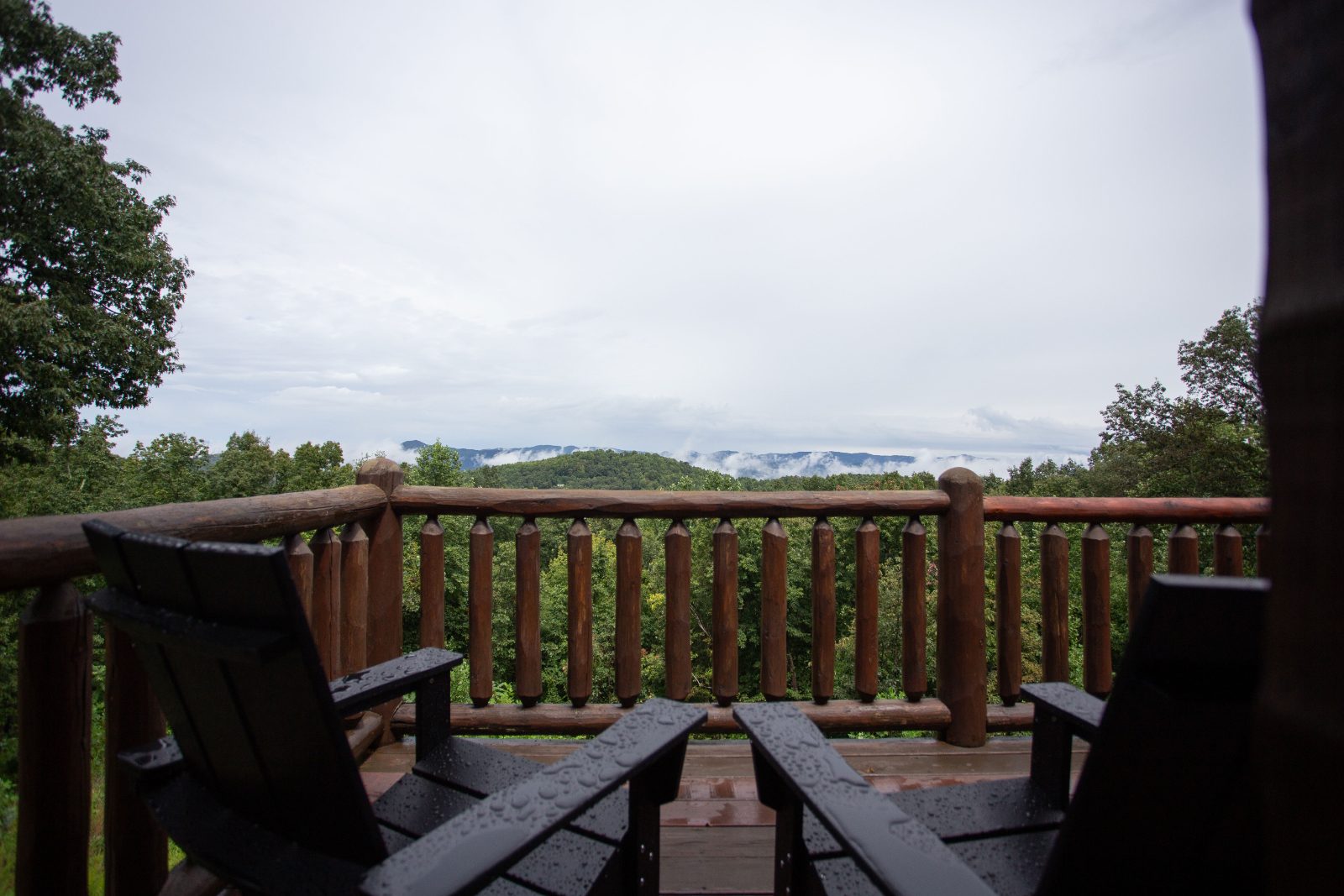 Adirondack chairs on the log balcony overlooking the mountains