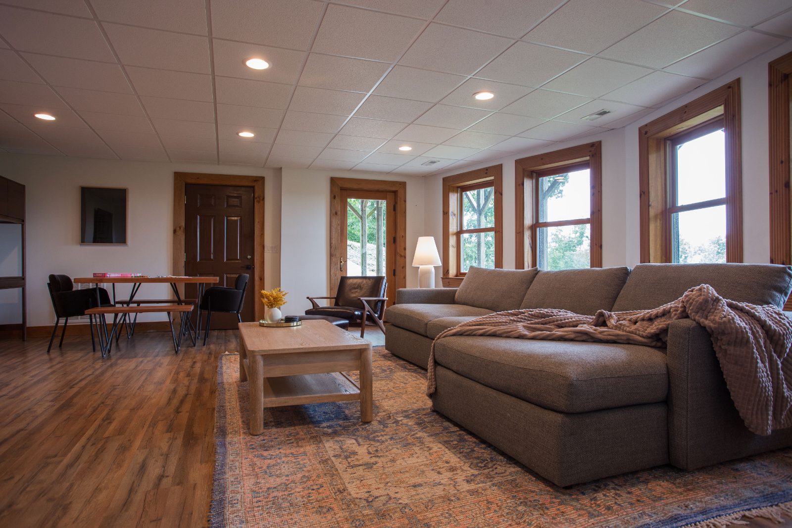 Walkout basement living room with sectional and 60-inch TV
