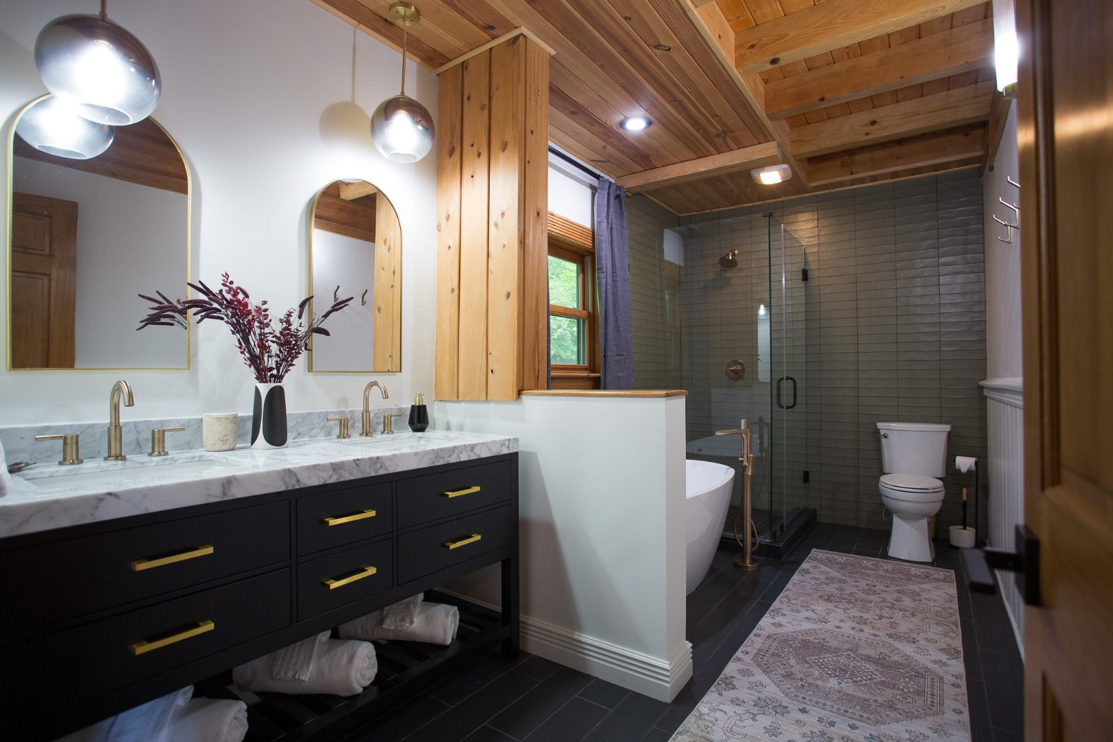 Renovated bathroom with double vanity, freestanding tub and glass shower