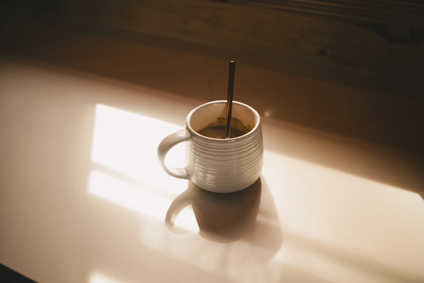 A mug of coffee catching the morning sun