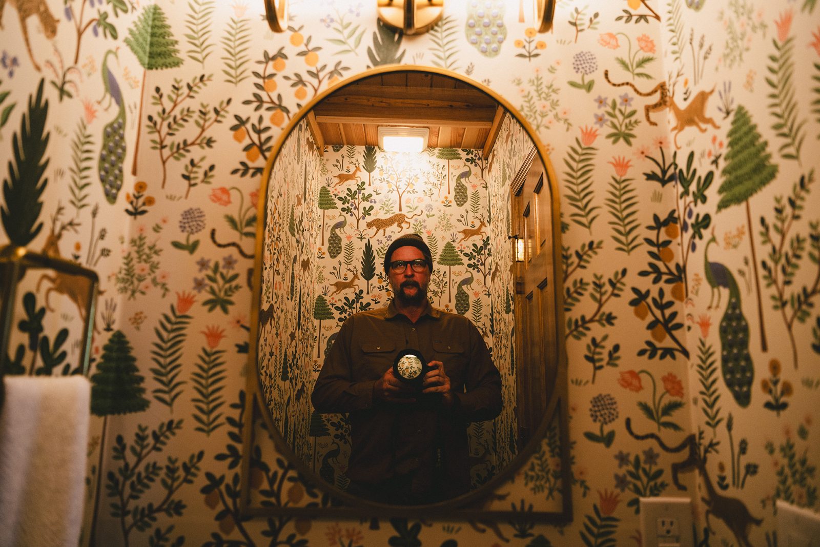 Josh's self-portrait in the wallpapered powder room mirror