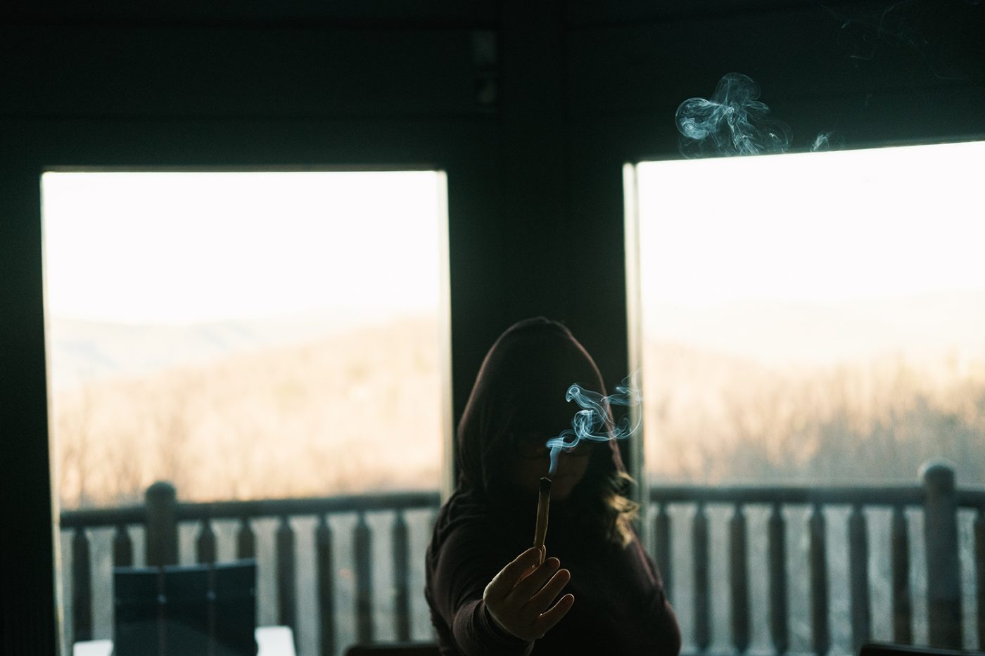 Steam rising from a mug on the porch at first light