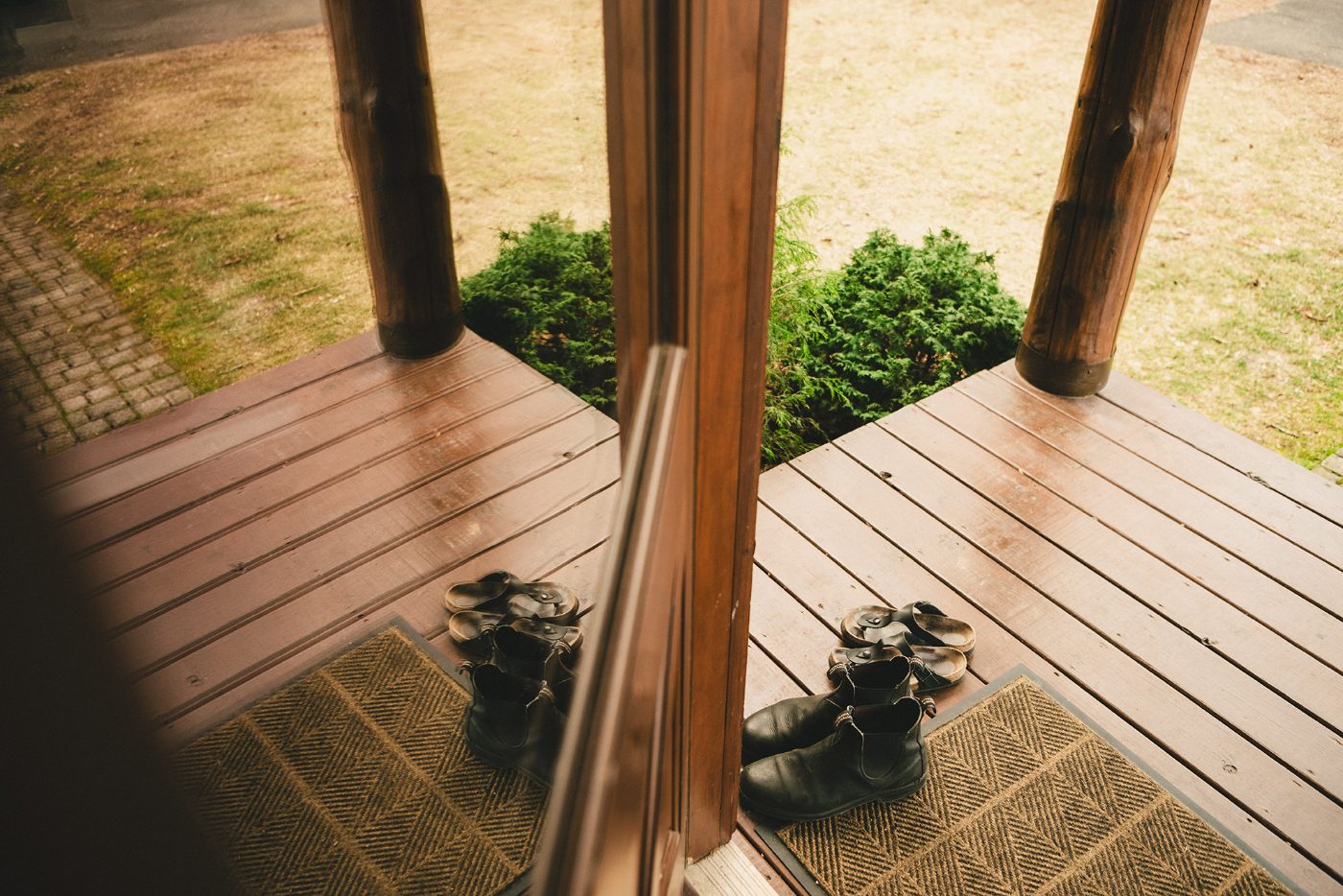 Boots by the porch rail in morning light