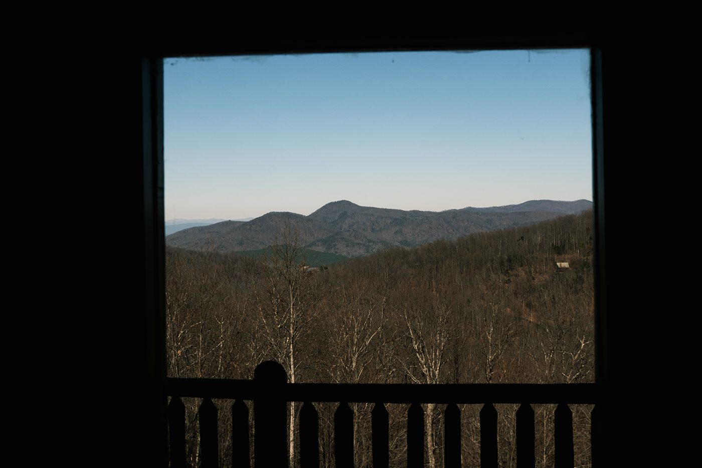 Blue Ridge mountains framed by a cabin window