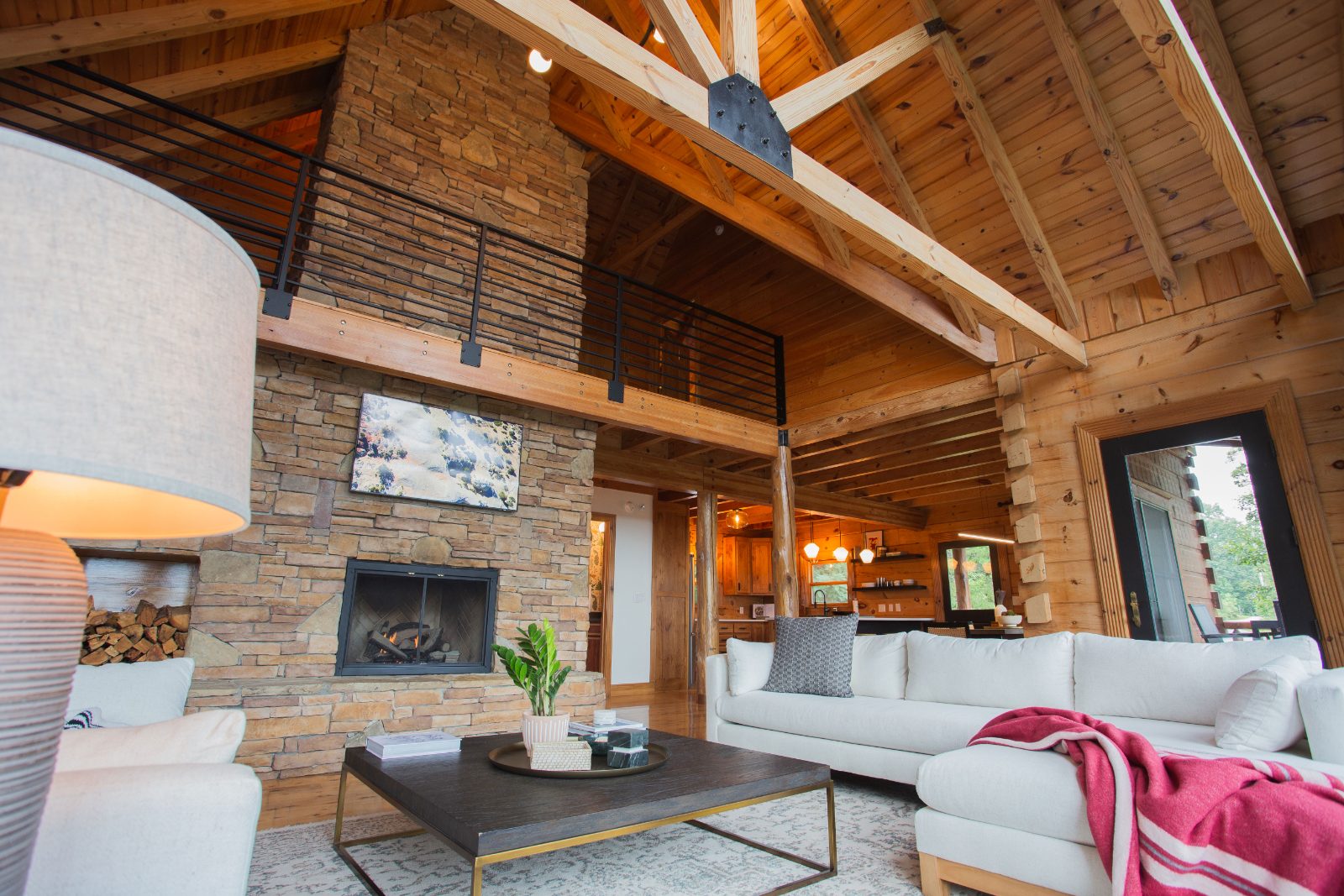 Main living room with stone gas fireplace and white sectional