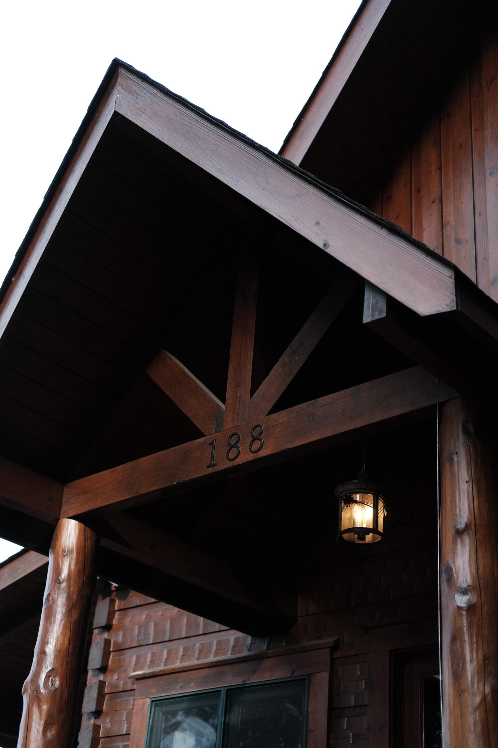 Timber entry porch with lantern at dusk