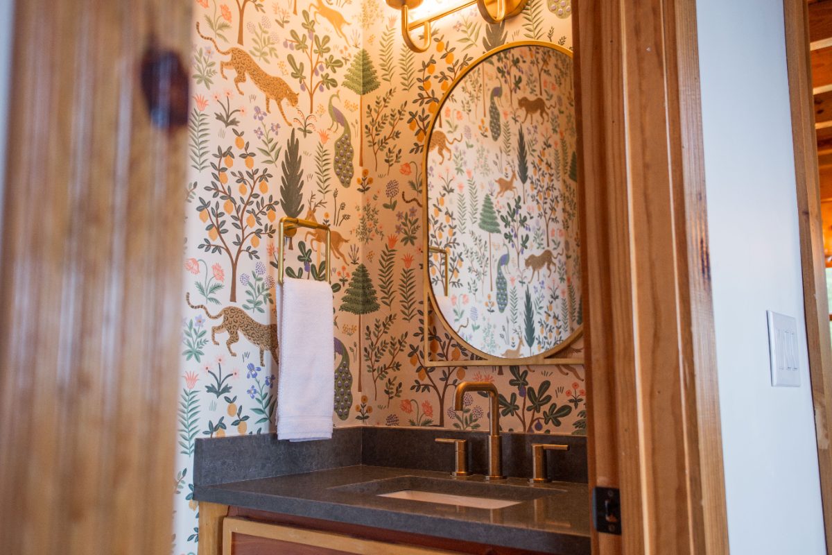 Powder room with forest wallpaper
